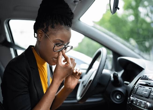 Driver noticing an unpleasant odor inside her car